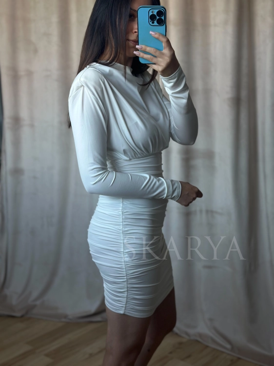 Dopasowana biała sukienka mini z długim rękawem i podkreśloną linią ramion. To model, który łączy nowoczesną elegancję z ponadczasową kobiecością, pozwalając stworzyć stylizację przyciągającą spojrzenia. Smart casual. Bodycon